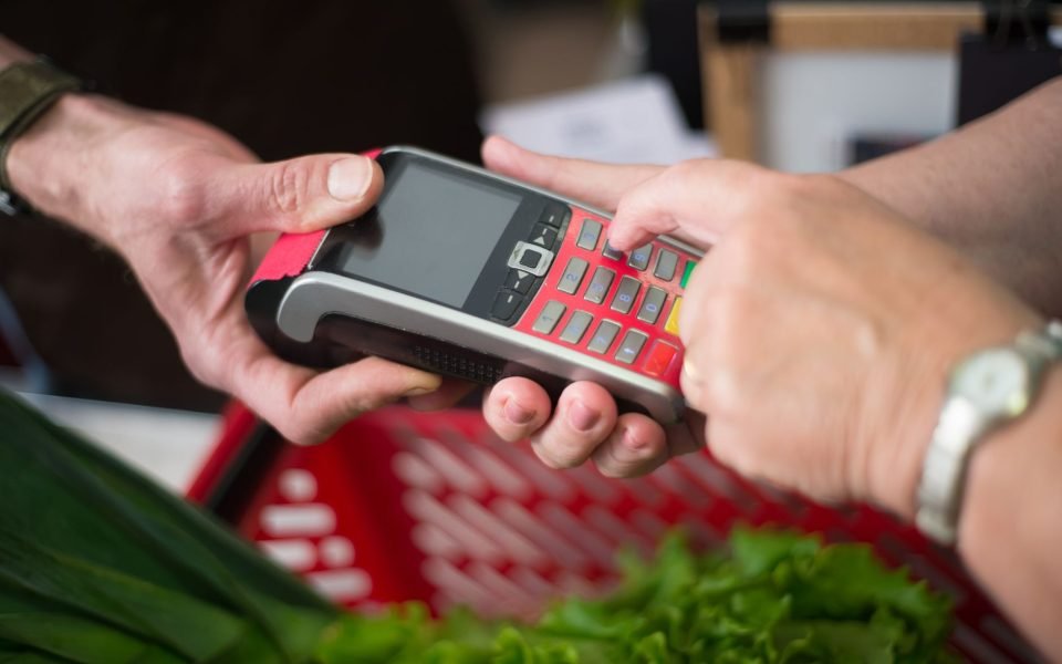 SumUp mobile card reader paired with a smartphone