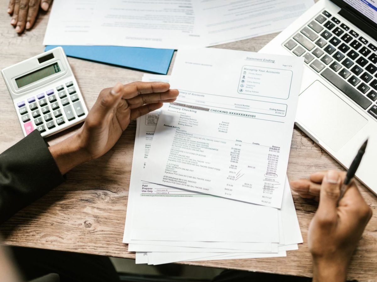 Accountant reviewing financial records and a calculator at a desk