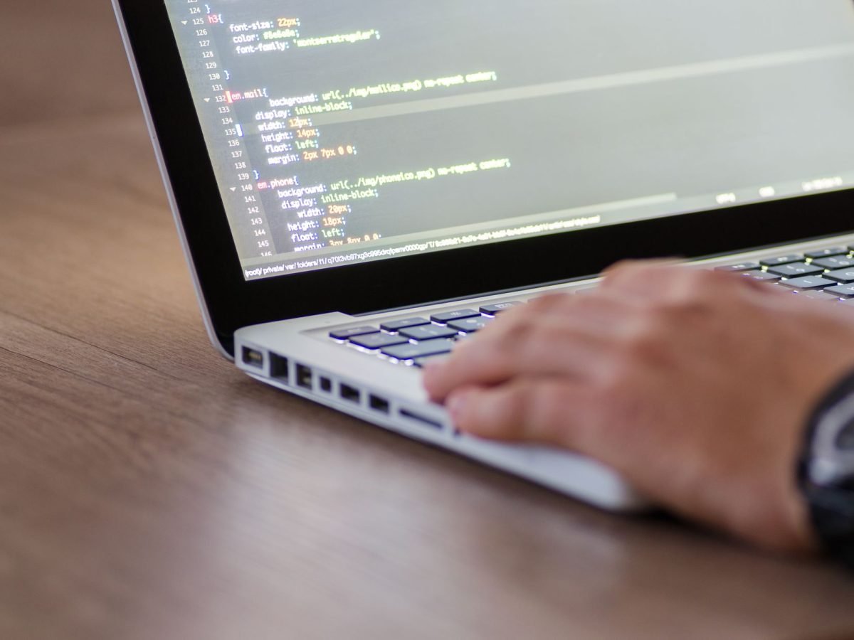 Web designer working on a website layout at a desk